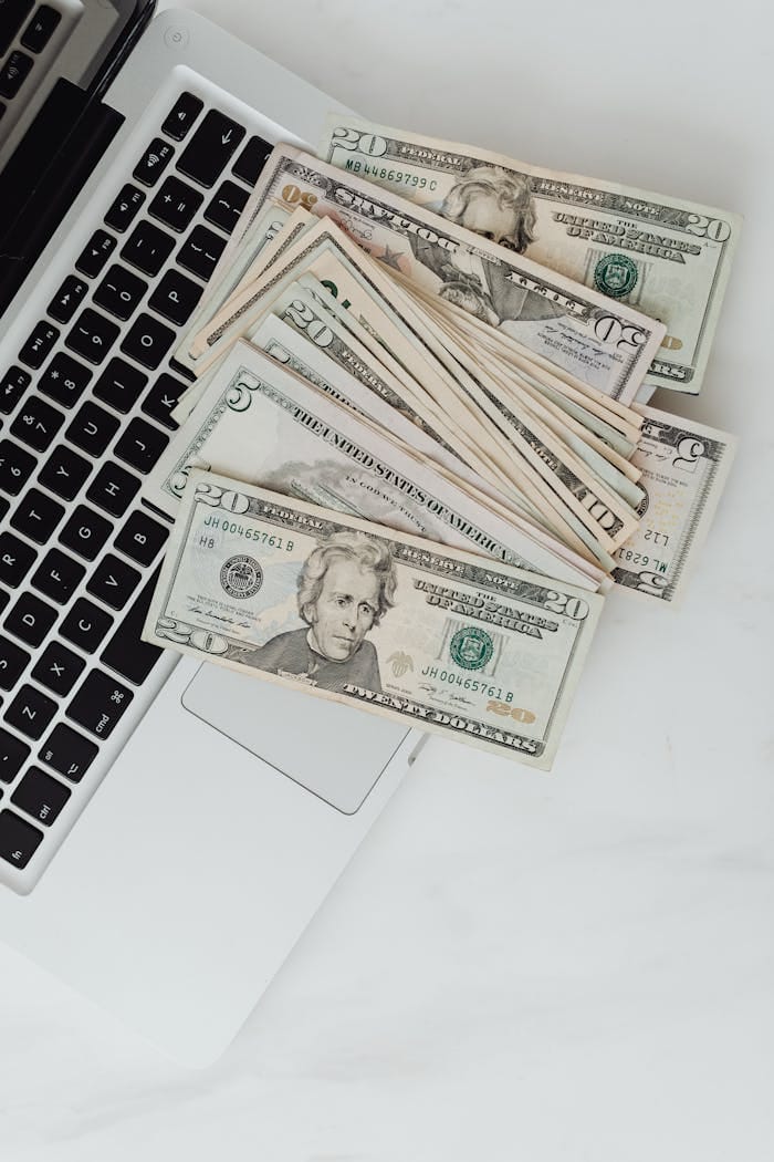 Home 1 dollars scattered on laptop 5942625