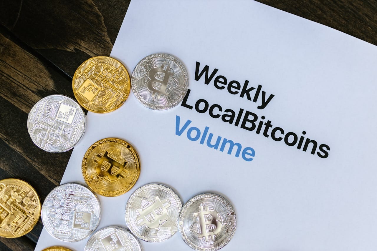 Offerings 4 silver and golden bitcoin tokens scattered over a finance report 8370771